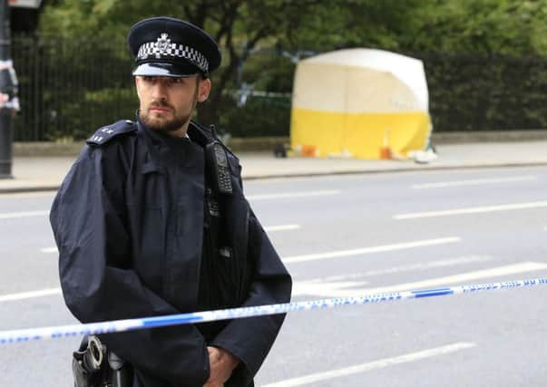 A police officer stands guard near a tent in Russell Square, central London, after a knife attack in which a woman in her 60s was killed and five people were injured. A 19-year-old man has been arrested. PRESS ASSOCIATION Photo. Picture date: Thursday August 4, 2016. See PA story POLICE Attack. Photo credit should read: Jonathan Brady/PA Wire.