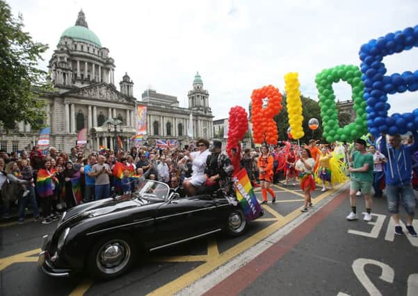 Participants pass city Hall as they take part in Belfast's annual Pride parade 2016