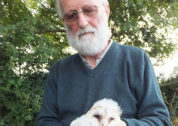 Farmer Michael Calvert with one of the barn owl chicks which was born on a nest box on his farm near Greyabbey this summer, one of only three known nest sites in Northern Ireland.