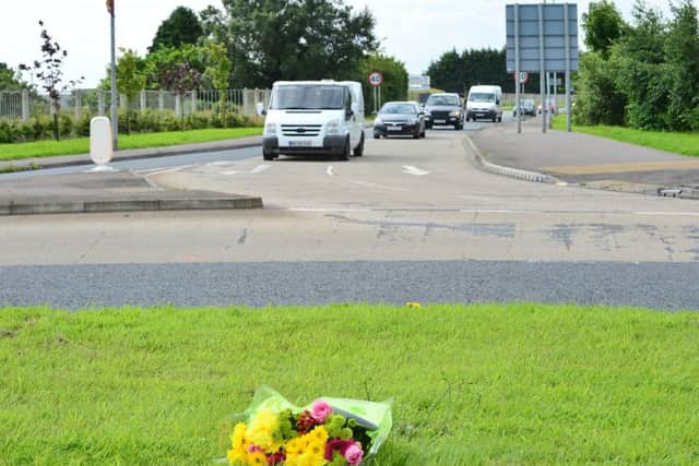 A bouquet of flowers left at the scene on the Comber Road, Newtownards, where a motorcyclist in his fifties was killed in a crash on Thursday night