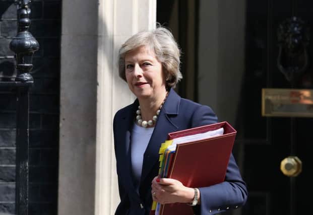 Prime Minister Theresa May leaves 10 Downing Street ahead of PMQs