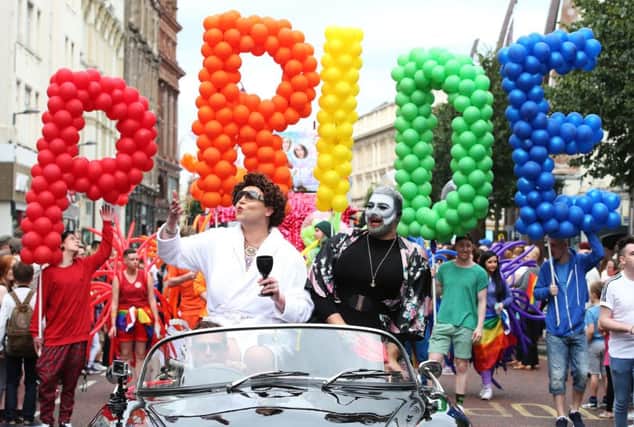 People take part in Belfast's annual Pride parade. PRESS ASSOCIATION Photo. Picture date: Saturday August 6, 2016. Calls for an end to Northern Ireland's ban on same sex marriage found colourful voice on the streets of Belfast as thousands packed the city centre for the annual Pride parade. Many of those taking part in the noisy carnival used the opportunity to demand a change to legislation. See PA story ULSTER Pride. Photo credit should read: Brian Lawless/PA Wire