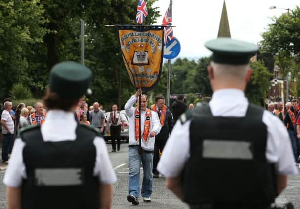 A member of the Ballysillan Loyal Orange Lodge (LOL) 1891 takes part in a final parade flashpoint protest on Woodvale Road, Belfast, having announced on Friday that it was suspending its participation. PRESS ASSOCIATION Photo. Picture date: Saturday August 6, 2016. See PA story ULSTER Orange. Photo credit should read: Brian Lawless/PA Wire
