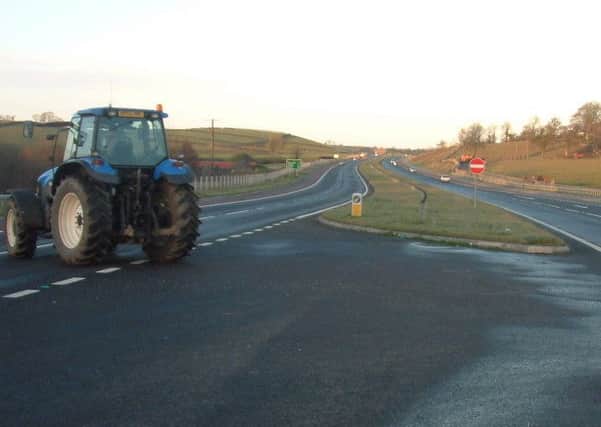 A tractor crossing through a gap junction on the A1 road between Loughbrickland and Beech Hill, shortly after the road opened in late 2006. Such junctions are rarely now built in dual carriageways and are implicated in many accidents. Pic by Ben Lowry taken before he worked for News Letter