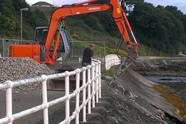 A council digger begins repairs at Larne promenade