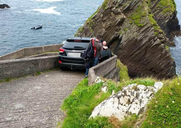 The car was wedged on a walkway used by ferry passengers making their way from Dunquin to the Blasket Islands off Co Kerry in Ireland