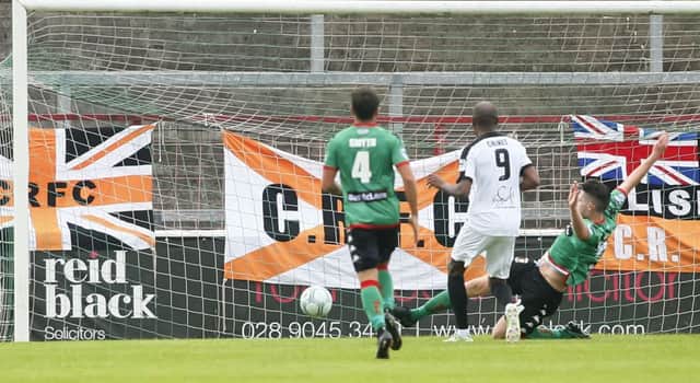 Carrick Rangers' Miguel Chines slots home the only goal against Glentoran. Pic by PressEye Ltd.