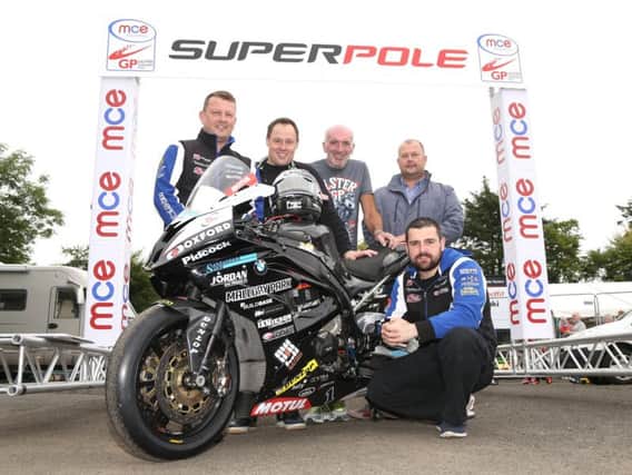 Michael Dunlop, who will start at number 1 on his Hawk BMW in the rescheduled Superpole session on Saturday at the MCE Ulster Grand Prix, is joined by Clerk of the Course, Noel Johnston and sponsors Darren and Mark McKinstry of McKinstry Skip Hire and James Jamieson of James Jamieson Construction.