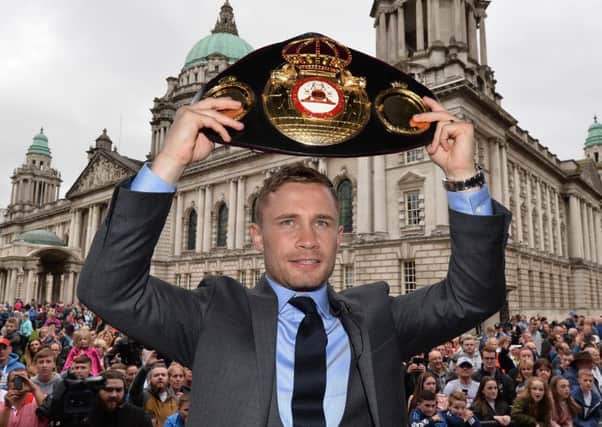 Carl Frampton shows off his WBA featherweight belt to fans at Belfast City Hall on Friday night