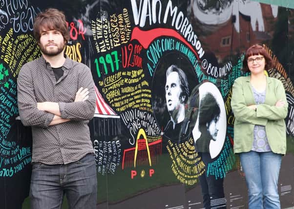 Artist Peter Strain and poet Emma Must at the completed wall