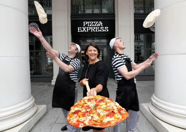 Operations director at Pizza Express Zoe Bowley is pictured alongside two of the restaurants Pizzaiolos at the new store in St. Annes Square