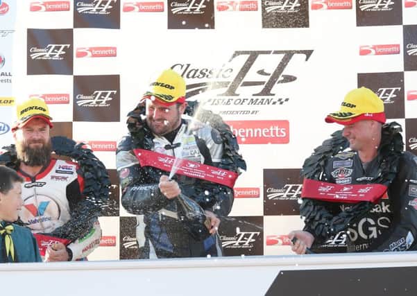 Michael Dunlop (Team Classic Suzuki) celebrates winning the Formula One race at the Classic TT in the Isle of Man last year with runner up Bruce Anstey (Valvoline Padgetts Yamaha) and third placed Ryan Farquhar