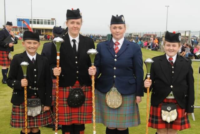 Alicia Dickson Hamilton (second from right) who won the Adult Grade Drum Major trophy, at the North West Pipe Band Championships at Portrush with Melissa Burrows and Lauren and Grace Kerr