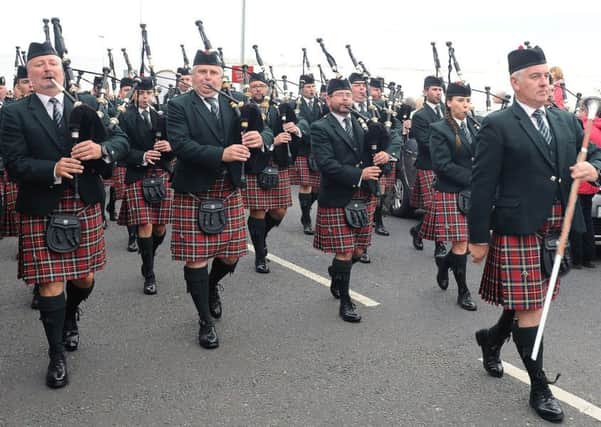 PSNI Pipe Band on parade through the crowded streets of Portrush