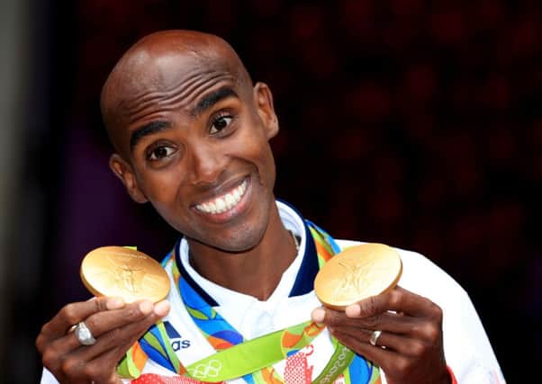 Great Britain's Mo Farah with his gold medals for victory in the Men's 5000m and 10000m
