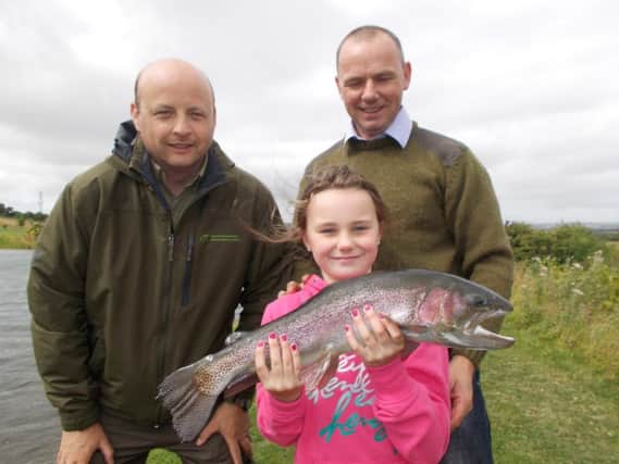 Alana Kerr (age 9) of Dunmoe, Co.Meath with Brendan Kerr, and Oisin Cahill, Co-Ordinator of Inland Fisheries Ireland's Dubling Angling Initiative