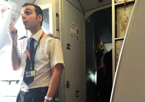 Undated handout photo issued by Dan Lobb of an easyJet captain making an announcement to passengers on a flight from London Gatwick to Belfast which was delayed by over an hour after two members of the cabin crew were removed from the plane following a row