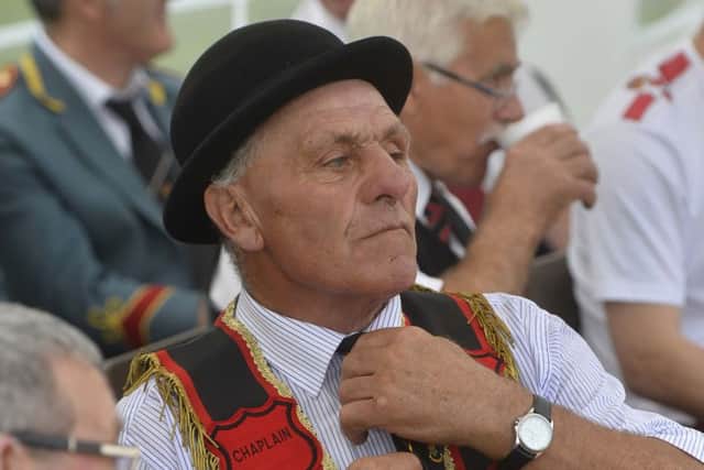 A preceptory member adjusts his tie during a break at the Castlederg parade