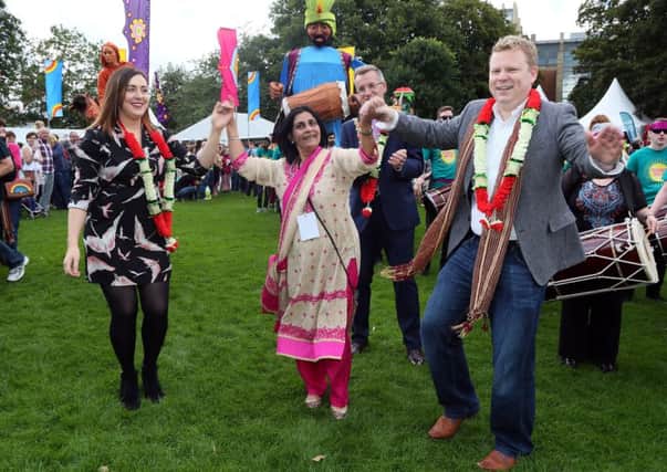 Junior ministers Megan Fearon and Alastair Ross get into the swing of Mela with Nisha Tandon, director of ArtsEkta, organisers of the Mela