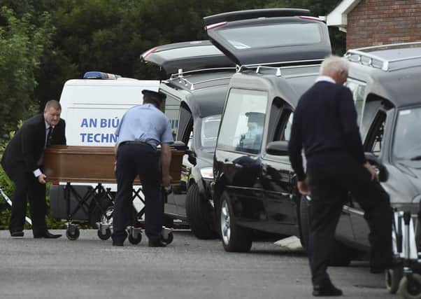 A coffin is loaded into a hearse at the scene in Barconey, Ballyjamesduff in Cavan, where a family of five was found dead in their countryside home