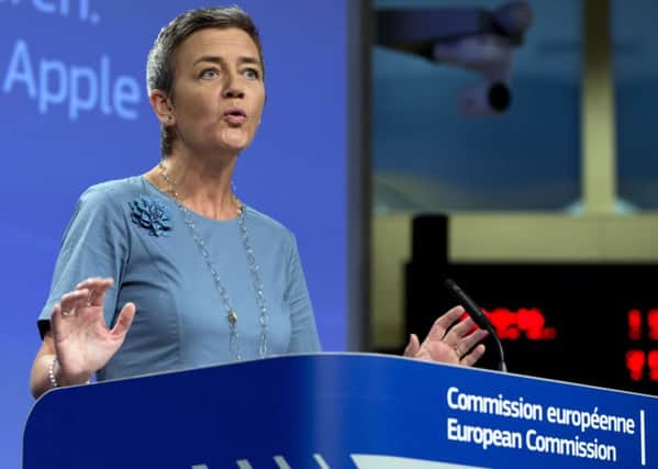 European Union Competition Commissioner Margrethe Vestager speaks during a media conference at EU headquarters in Brussels on Tuesday, Aug. 30, 2016. The European Union says Ireland has given illegal tax benefits to Apple Inc. and must now recover the unpaid back taxes from the U.S. technology company, plus interest. (AP Photo/Virginia Mayo)