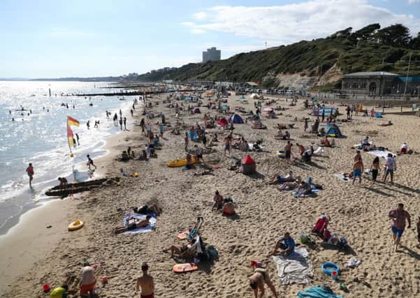People enjoying a spell of warm weather on the beach at Boscombe in Dorset. Photo: Andrew Matthews/PA Wire