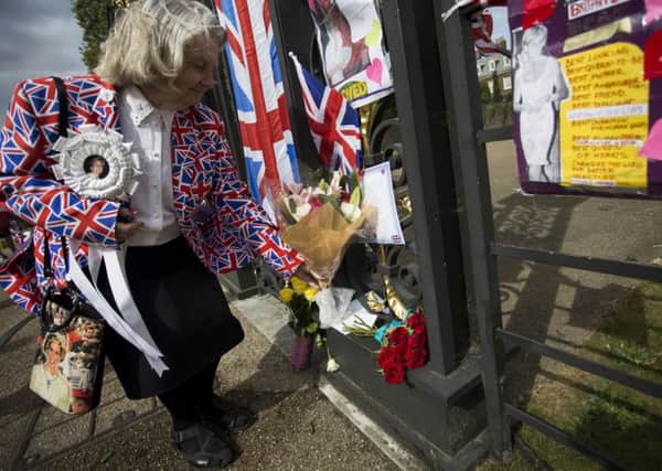 Royalist Margaret Tyler lays flowers outside Kensington Palace, London, on the anniversary of the death of Diana, Princess of Wales, who was killed in a car crash in central Paris along with Dodi Fayed