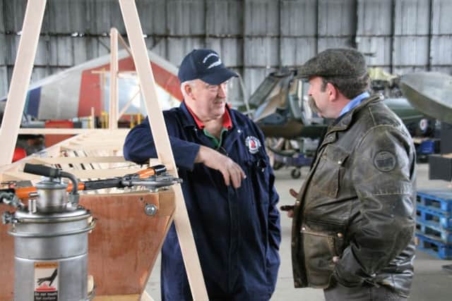 Steve Lowry (left) and presenter Dick Strawbridge during an assembly phase of the replica aircraft last spring