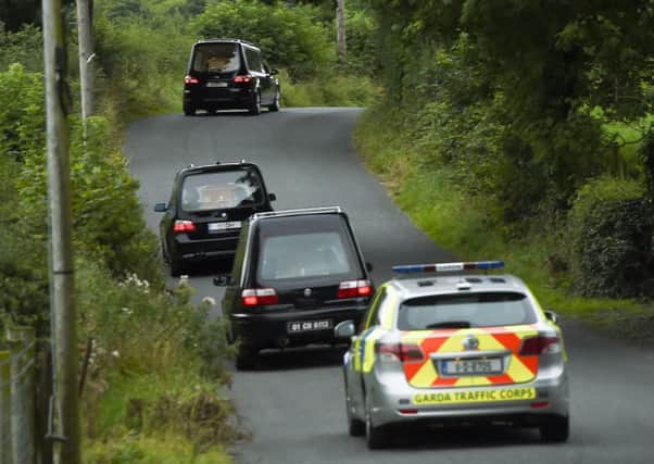Hearses leaves the scene at Ballyjamesduff on Monday after the five bodies were discovered