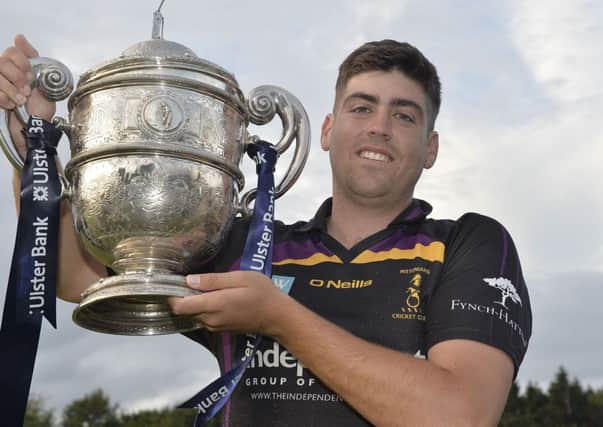 Nikolai Smith with the Ulster Bank Premier League trophy