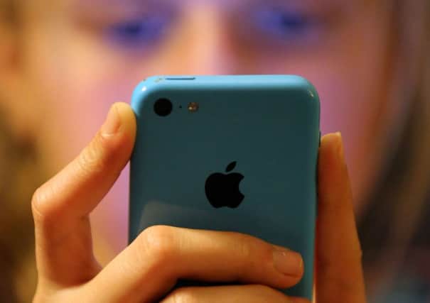 A general view of a teenager using a mobile phone. More than 2,000 children were reported to police for crimes linked to indecent images in the space of three years. Photo: Chris Radburn/PA Wire