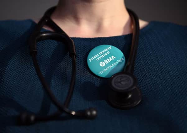 A doctor wearing a BMA badge next to her stethoscope. Photo: Andrew Matthews/PA Wire