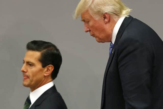 Republican presidential candidate Donald Trump, right, walks behind Mexico's President Enrique Pena Nieto after delivering statements in Mexico City, Wednesday, Aug. 31, 2016. (AP Photo/Dario Lopez-Mills)