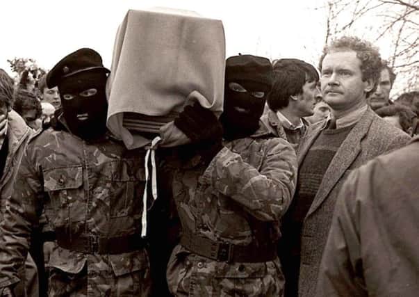 Sinn Fein vice President Martin McGuinness pictured with masked IRA men at the funeral of Brendan Burns PACEMAKER 1988