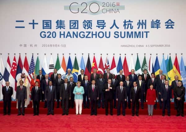 State leaders take part in a group photo session for the G20 Summit held at the Hangzhou International Expo Center in Hangzhou in eastern China's Zhejiang province, Sunday. (AP Photo/Ng Han Guan)