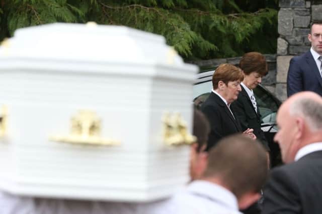Mourners bow their heads as one of the children's coffins is taken into Saint Mary's Church in Castlerahan, Co Cavan, where the funeral of the Hawe family - Alan and his wife Clodagh along with their children Liam, 13, Niall, 11 and Ryan, 6 - is taking place. PRESS ASSOCIATION Photo.