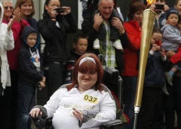 Disabled sports fan Michaela Hollywood carried the Olympic flame

in Dromore in June 2012 before the London Games