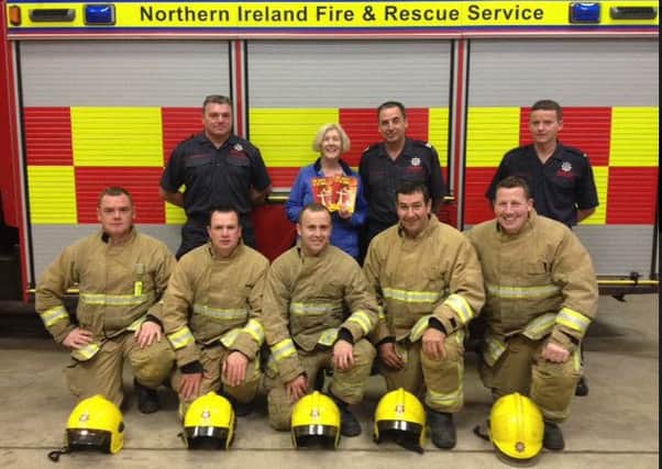 Kathleen Hughes pictured with firefighters from Keady Fire Station who responded to a chimney fire in her home.  INNL 36-661-CON