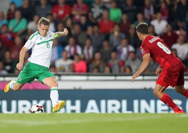 Northern Ireland skipper Steven Davis hits a shot in the game against the Czech Republic