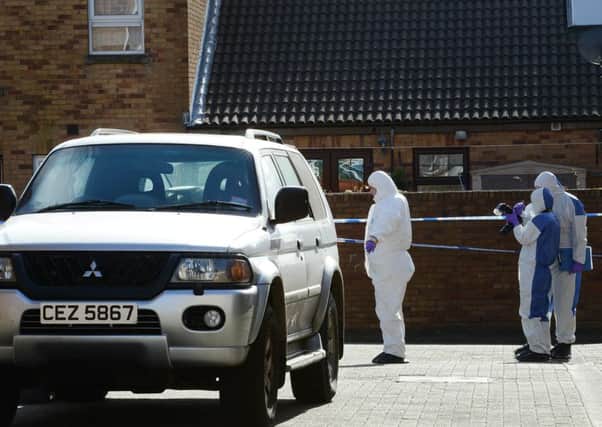 Police forensic officers on the scene in Ardoyne following the murder in 2014