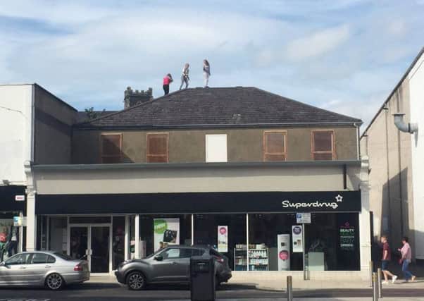 Youngsters on a roof top in Larne on Tuesday August 30