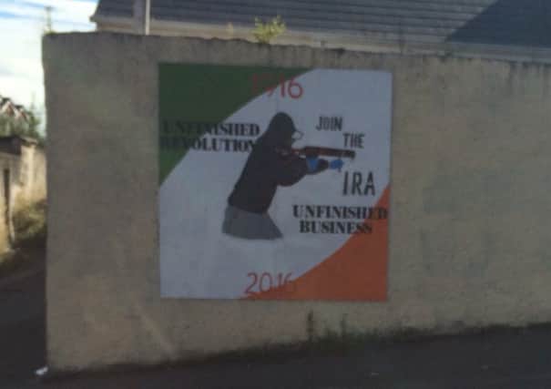 The poster erected at the Westland area of the Bogside in Londonderry, which reads: Unifinished revolution, unfinished business. Join the IRA