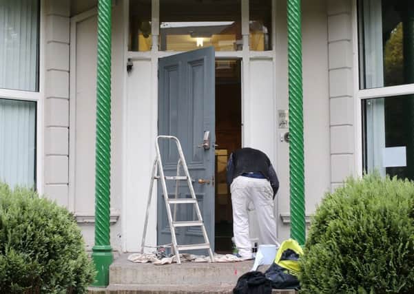 A painter covers up paint which was thrown at the Belfast Islamic Centre in south Belfast on Monday night