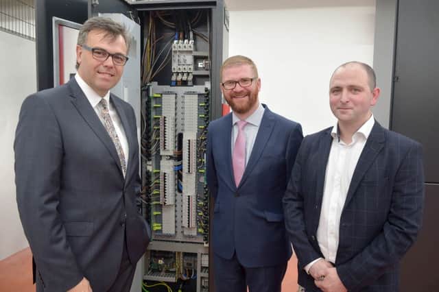 Minister Simon Hamilton with Invest NI CEO Alastair Hamilton and Colum Hadden, MD of Critical Power Systems