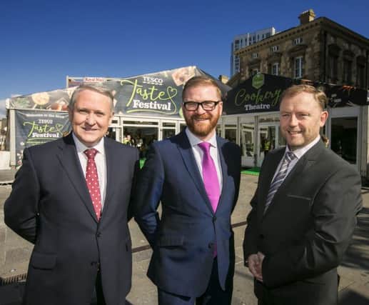 Minister Simon Hamilton pictured at the Tesco Taste Festival with Brendan Guidera, left, store director Tesco NI, and commercial manager Sean Largey