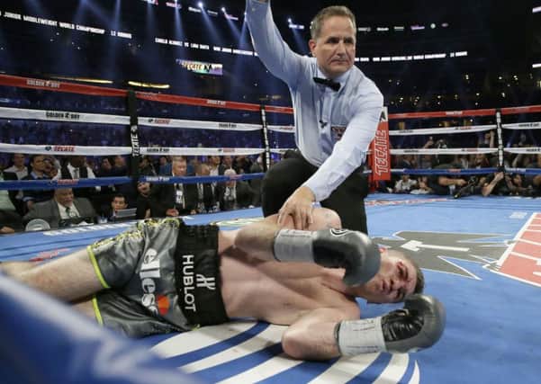 Liam Smith lays on the mat as referee Luis Pavon calls the knock out by Canelo Alvarez during the ninth round