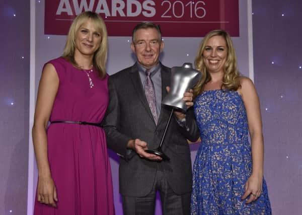 Pictured on stage receiving his Lifetime Achievement Award is Richard Finlay of Douglas & Grahame with Kirsty McGregor, left, and Keeley Stocker of Drapers Magazine