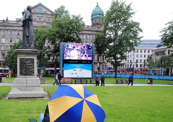 Tennis fans enjoy Wimbledon on the front lawn of City Hall in 2012.