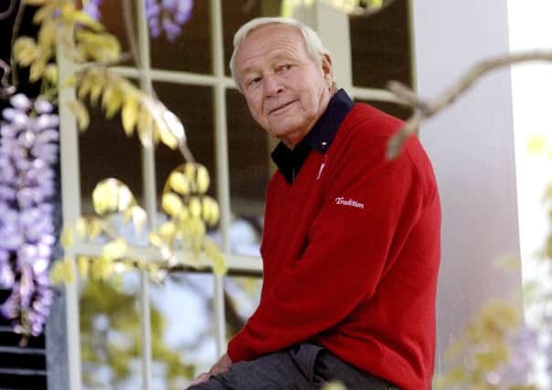 This 2004 file photo shows former Masters champion Arnold Palmer as he sits on clubhouse railing at the Augusta National Golf Club in Augusta.