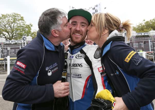 Lee Johnston celebrates his first Isle of Man TT podium in 2015 with his late father Everitt (left) and mum Audrey.